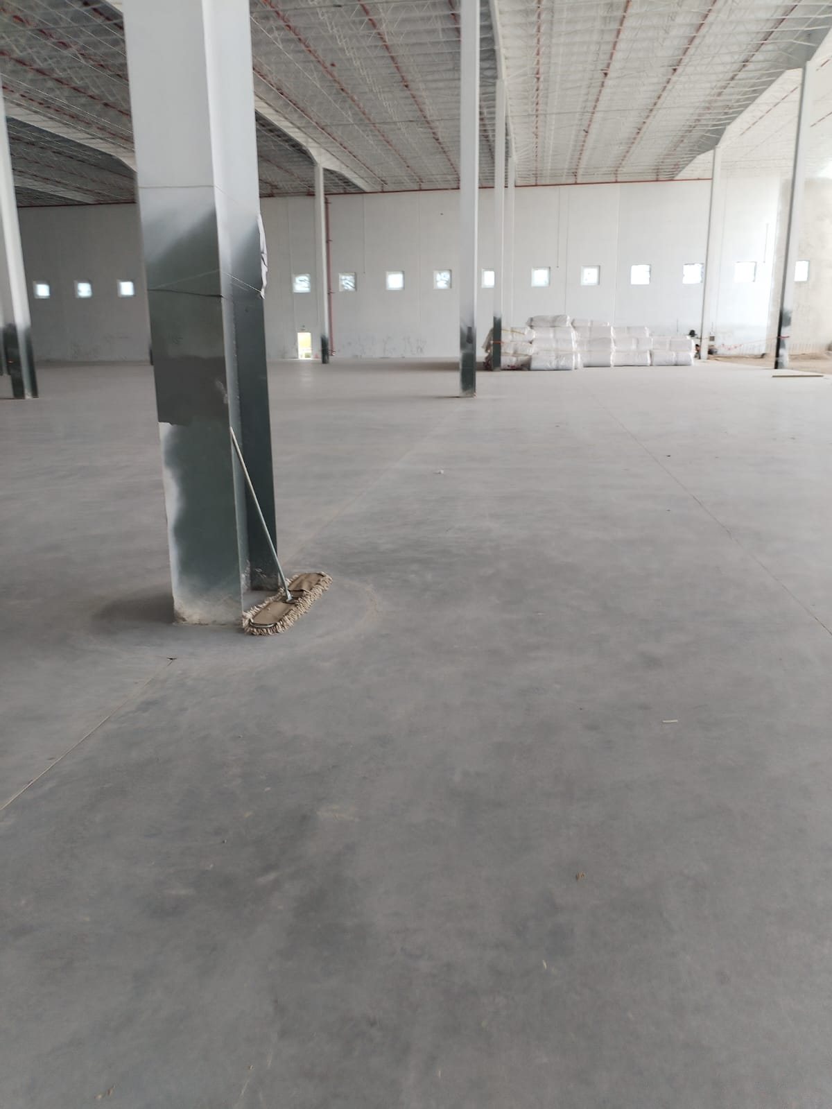 Piso de concreto pulido en interior de nave — control de calidad CIMTRA en gerencia de obra